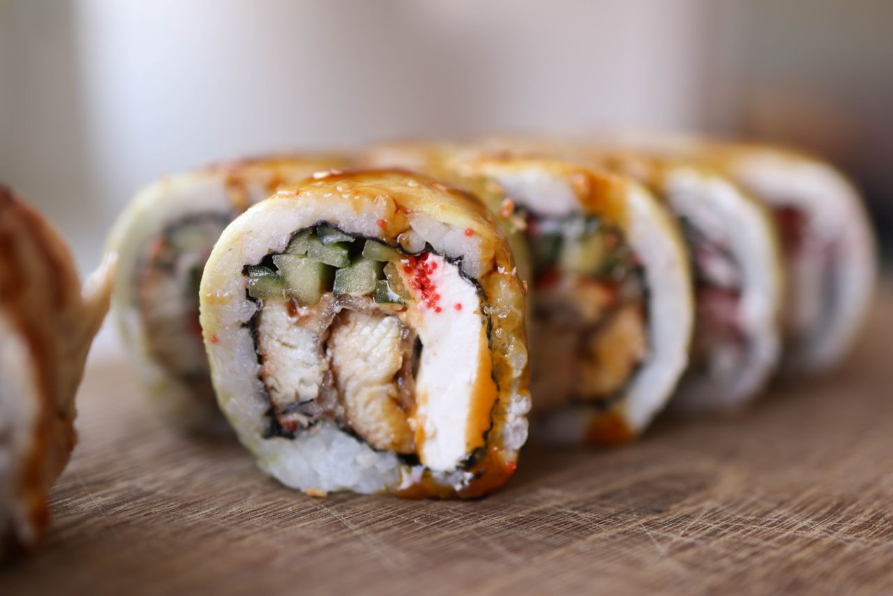 The Art of Drawing Readers In: Your attractive post title goes here Mouthwatering sushi rolls with a variety of ingredients on a wooden board.